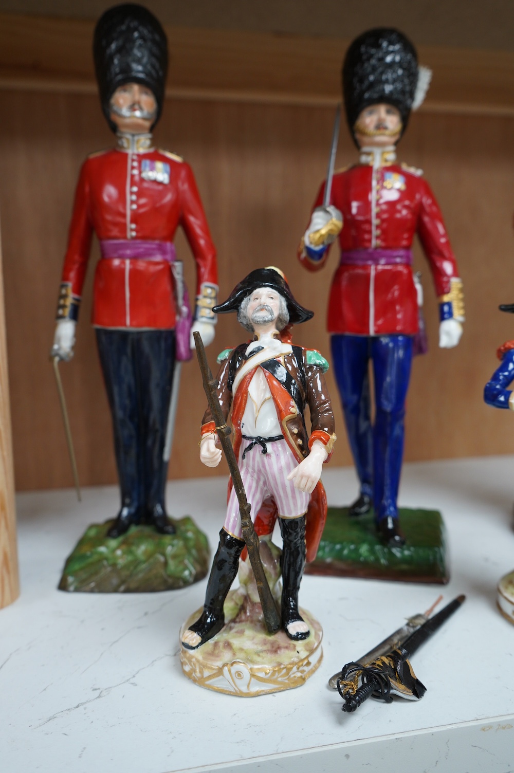 A pair of Sevres style Napoleonic figures and three others including Worcester, tallest 30cm. Condition - fair to good